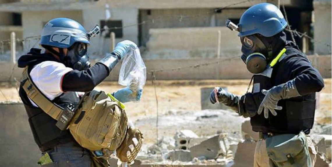 Source: Global News. Members of the UN investigation team taking samples from sand near Damascus